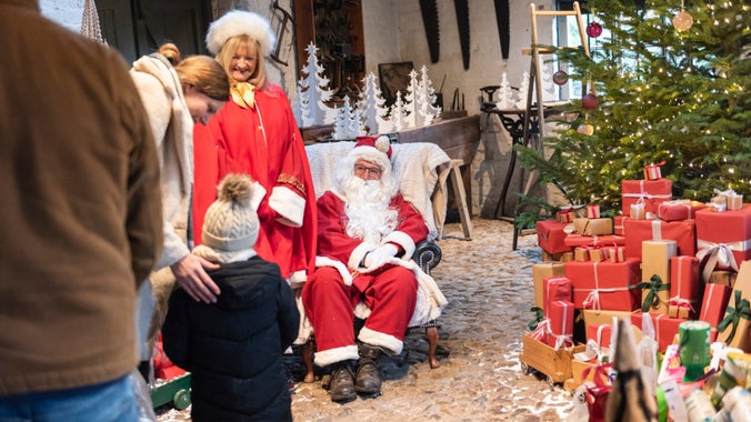 Father Christmas in his grotto at Erddig, surrounded by visitor’s donations to the local foodbank.